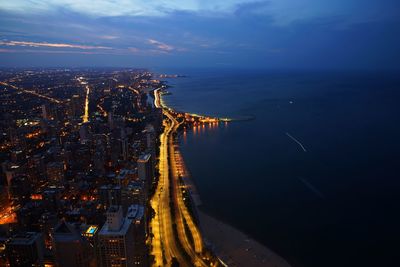 High angle view of city lit up at night