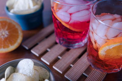 Two spritz with some chips on the table ready for the appetizer