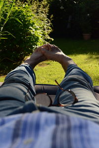 Low section of man lying on grass