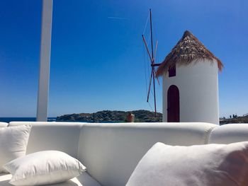 Pillows on sofa by traditional windmill at mykonos