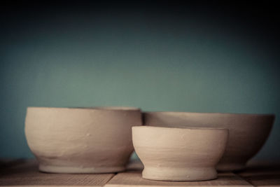 Close-up of bowl on table against wall