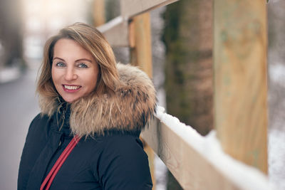 Portrait of smiling mature woman wearing warm clothing during winter