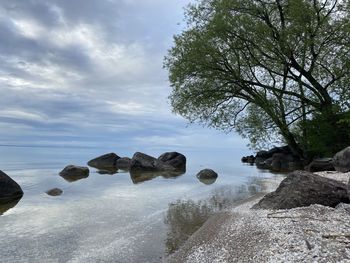 Scenic view of rocks in sea against sky