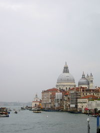 Santa maria della salute by grand canal against sky during foggy weather