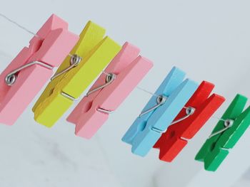 High angle view of multi colored clothespins on table