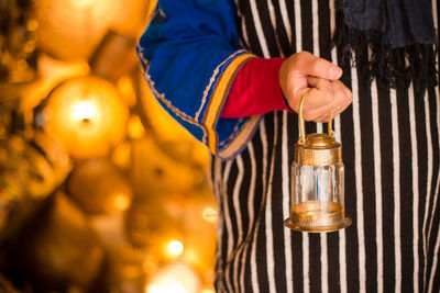 Close-up of hand holding illuminated lighting equipment