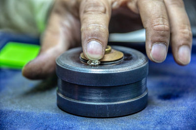 Close-up of man working on metal