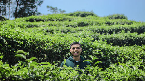 Portrait of young man amidst plants