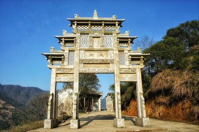 Traditional stone gate against sky