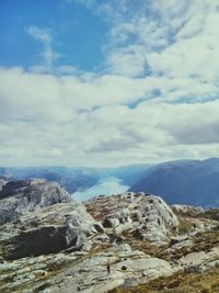 Scenic view of mountains against cloudy sky