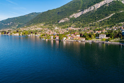 Scenic view of sea by town against sky