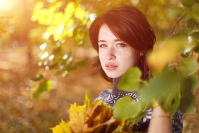 Outdoor portrait of young caucasian woman in knitted sweater posing on