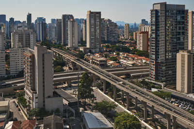 High angle view of street amidst buildings in city against sky