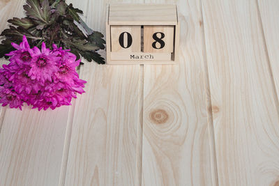 Close-up of flower bouquet and calendar on table