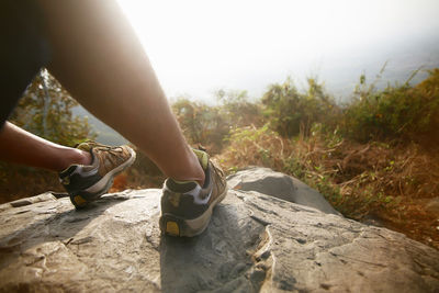 Low section of woman on rock