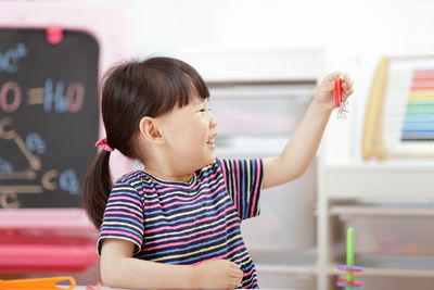 Young girl playing science experiment at home 