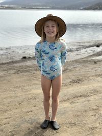 Portrait of woman standing at beach