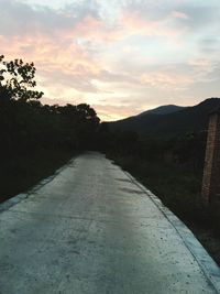 Empty road leading towards mountains