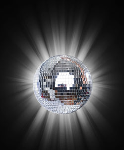 Illuminated disco ball hanging from ceiling