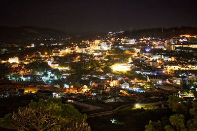 High angle view of illuminated buildings in city at night