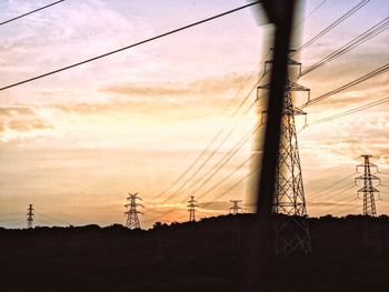 Low angle view of electricity pylon against sky