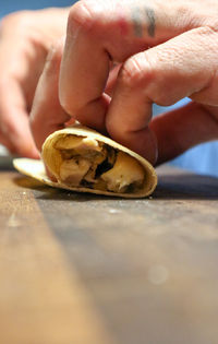 Close-up of person holding hands on table