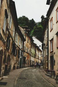 People walking on street in city against clear sky