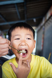 Portrait of cute boy eating food