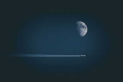 Low angle view of vapor trails in sky at night