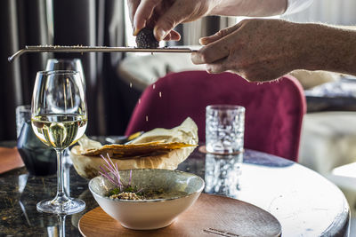 Midsection of person preparing food drink at restaurant