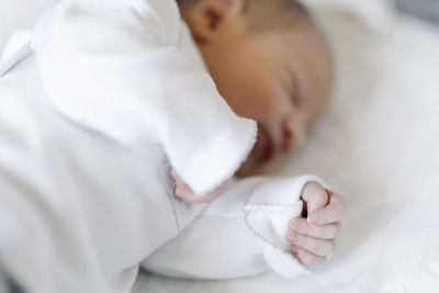 Newborn baby sleeping on bed