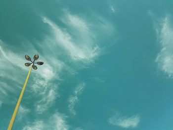 Low angle view of street light against blue sky