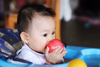 Close-up of cute baby girl at home