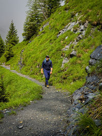 Rear view of man walking on mountain