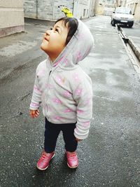 Girl standing on street in city