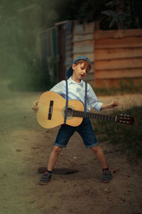 Full length of boy playing soccer