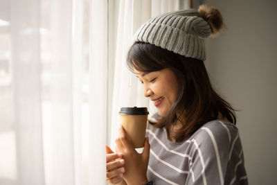 Portrait of young woman drinking coffee