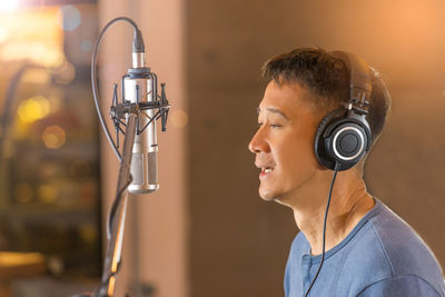 Close-up of man recording in studio