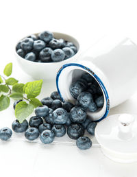 Freshly picked blueberries on a white tile background. concept for healthy eating