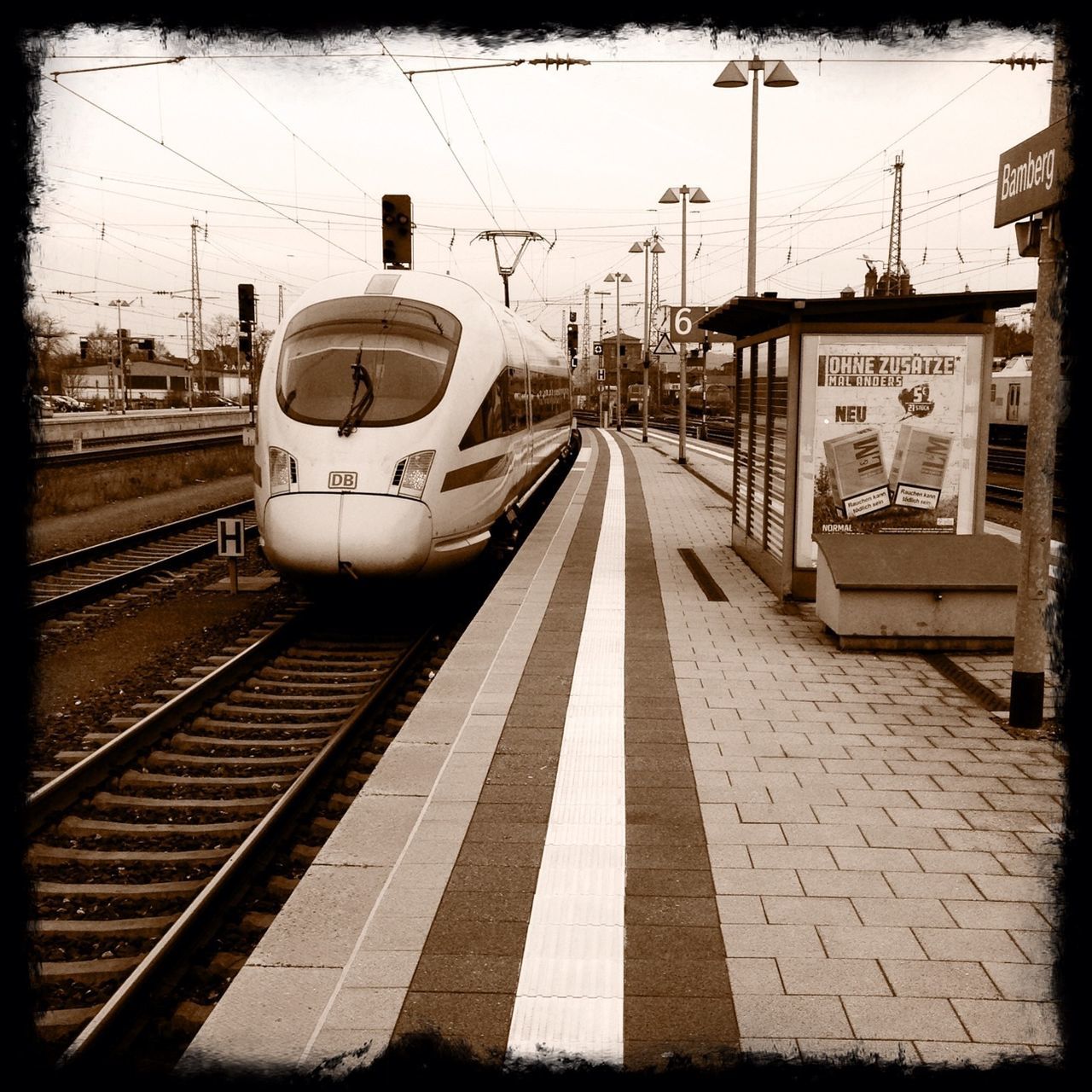 railroad track, transportation, rail transportation, public transportation, railroad station platform, railroad station, transfer print, power line, mode of transport, train - vehicle, built structure, building exterior, sky, architecture, the way forward, diminishing perspective, auto post production filter, public transport, travel, vanishing point