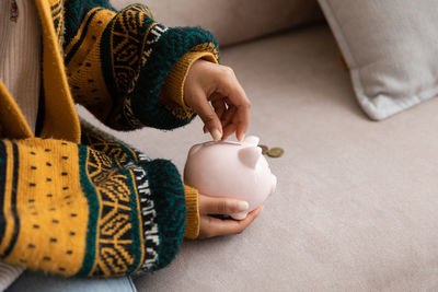 Midsection of woman holding coffee