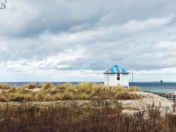 Lifeguard hut on beach against sky