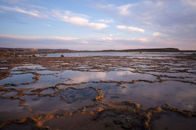 Scenic view of beach against sky during sunset