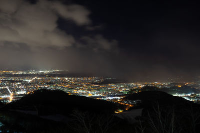 High angle view of illuminated buildings in city at night