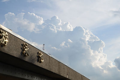 Low angle view of building against cloudy sky