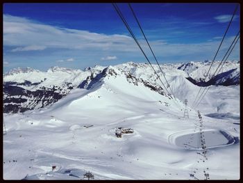 Scenic view of snow covered mountains against sky