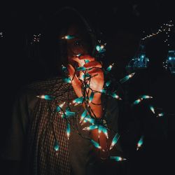 High angle view of man wearing sunglasses standing at night