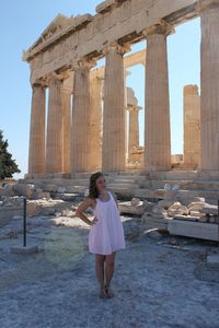 Full length of woman standing at historical building