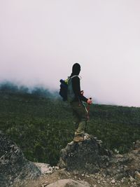 Young man standing in foggy weather