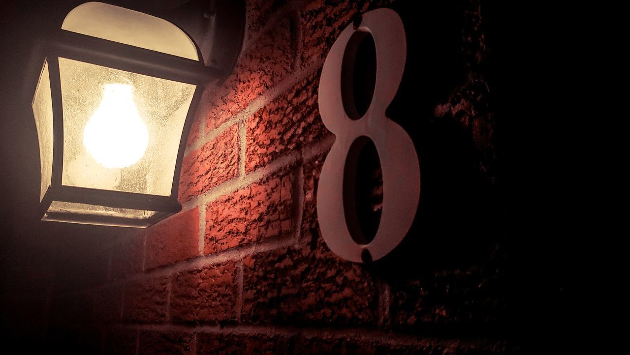 CLOSE-UP OF ILLUMINATED LIGHTING EQUIPMENT ON WALL